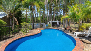 Hinterland property secured by Sunshine Coast Buyers Agent. View across pool to forrest